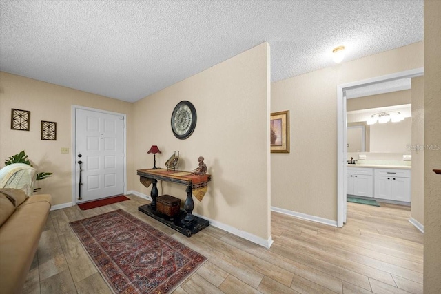 8461 SW 109th St, Ocala, FL 34481 - entryway with light wood-type flooring and a textured ceiling