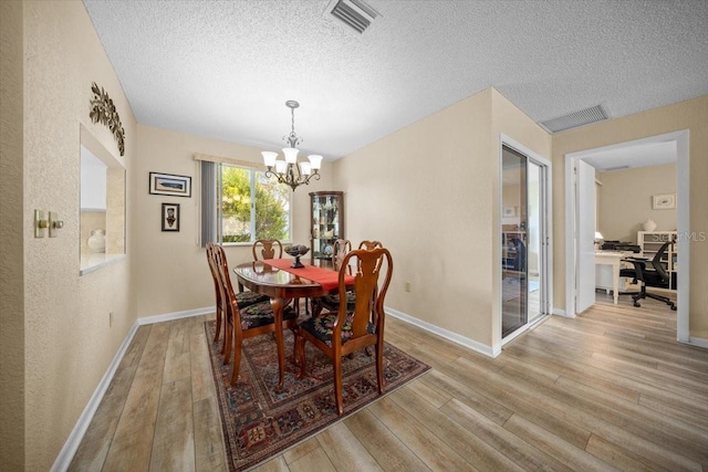 8461 SW 109th St, Ocala, FL 34481 - dining space featuring wood finished floors, a chandelier, a textured ceiling, and an office area