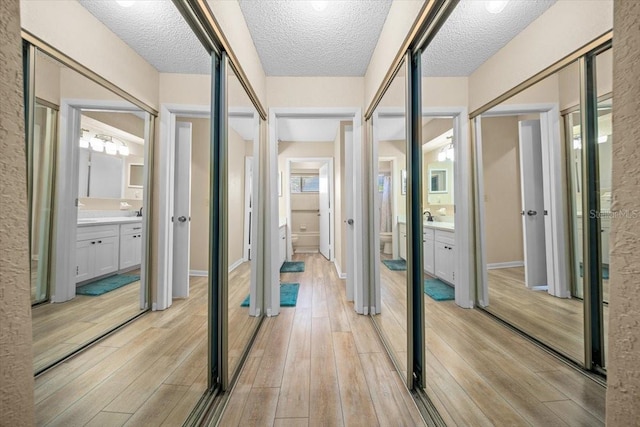8461 SW 109th St, Ocala, FL 34481 - hall featuring light wood-style flooring and a textured ceiling