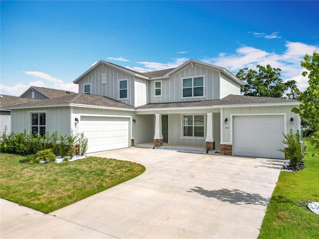 7067 SW 60th Ln, Ocala, FL 34474 - view of front of house featuring covered porch, driveway, a front lawn, and board and batten siding