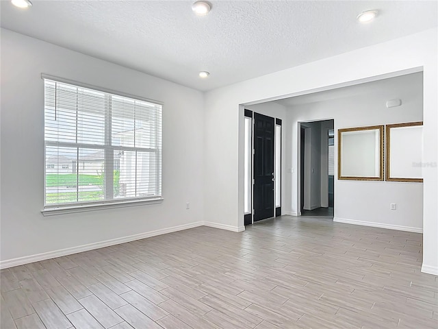 7067 SW 60th Ln, Ocala, FL 34474 - empty room featuring a textured ceiling, light wood finished floors, and recessed lighting
