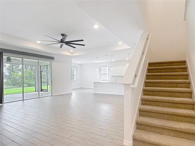7067 SW 60th Ln, Ocala, FL 34474 - unfurnished living room with recessed lighting, a raised ceiling, ceiling fan, and stairs