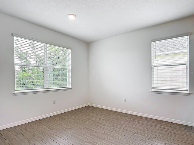 7067 SW 60th Ln, Ocala, FL 34474 - spare room with plenty of natural light and light wood finished floors
