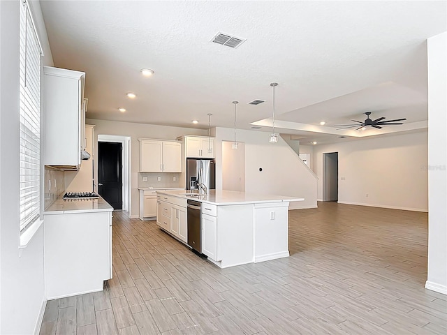 7067 SW 60th Ln, Ocala, FL 34474 - kitchen with stainless steel appliances, light wood-style flooring, light countertops, open floor plan, and recessed lighting
