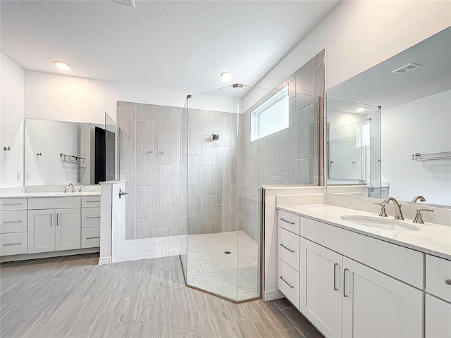7067 SW 60th Ln, Ocala, FL 34474 - bathroom with walk in shower, two vanities, wood finished floors, and recessed lighting