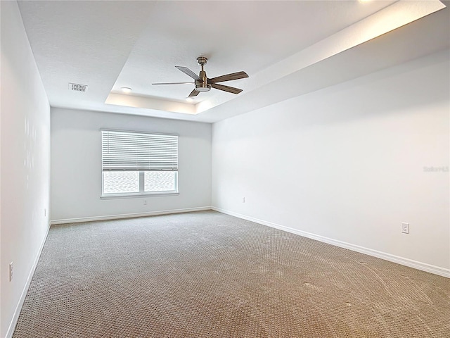 7067 SW 60th Ln, Ocala, FL 34474 - carpeted spare room featuring a tray ceiling and a ceiling fan