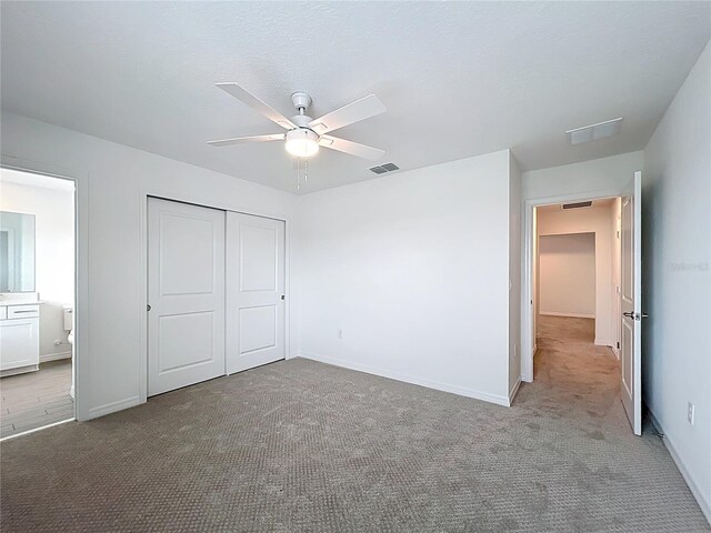 7067 SW 60th Ln, Ocala, FL 34474 - unfurnished bedroom featuring carpet floors, a closet, and a ceiling fan