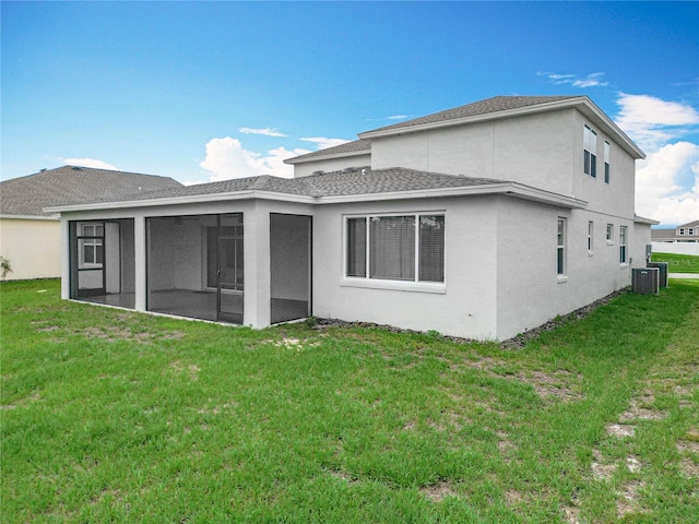 7067 SW 60th Ln, Ocala, FL 34474 - back of house with a sunroom, a lawn, stucco siding, and a shingled roof
