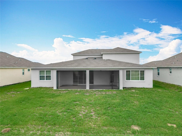 7067 SW 60th Ln, Ocala, FL 34474 - rear view of property with a sunroom, a yard, roof with shingles, and stucco siding