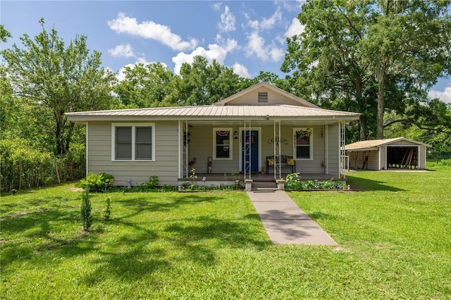 1330 NE 55th St, Ocala, FL 34479 - bungalow-style house featuring covered porch, a front lawn, and a metal roof