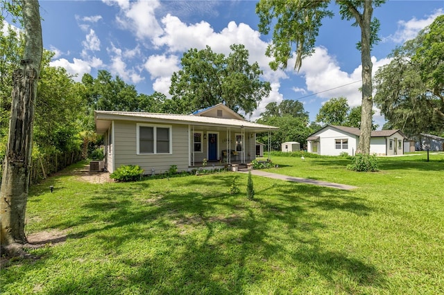 1330 NE 55th St, Ocala, FL 34479 - view of front of home featuring a porch, a front yard, and a metal roof