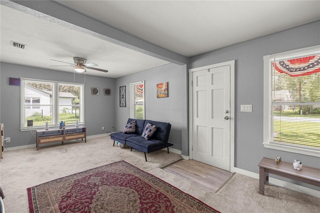 1330 NE 55th St, Ocala, FL 34479 - carpeted living room with healthy amount of natural light and a ceiling fan