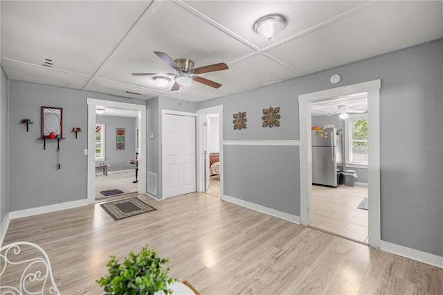 1330 NE 55th St, Ocala, FL 34479 - unfurnished living room featuring a ceiling fan and light wood-style floors