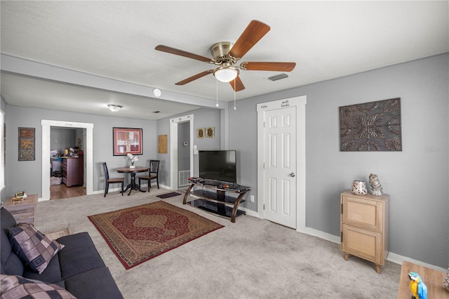 1330 NE 55th St, Ocala, FL 34479 - living room featuring a ceiling fan and light colored carpet