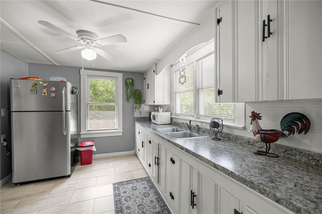 1330 NE 55th St, Ocala, FL 34479 - kitchen with freestanding refrigerator, plenty of natural light, white microwave, and ceiling fan
