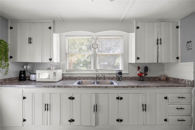 1330 NE 55th St, Ocala, FL 34479 - kitchen with white microwave and white cabinets