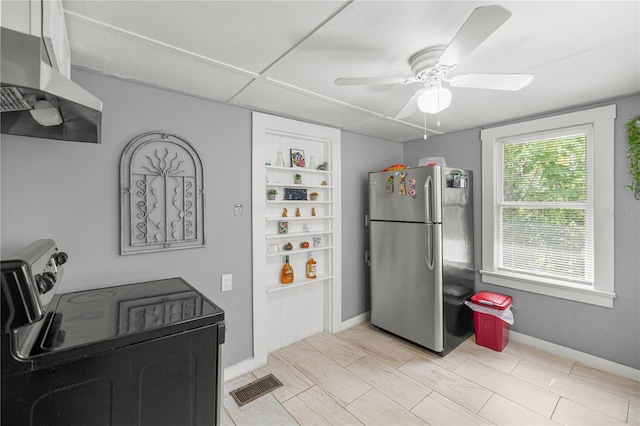 1330 NE 55th St, Ocala, FL 34479 - kitchen with freestanding refrigerator, black electric range, exhaust hood, and ceiling fan