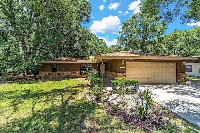 10615 SW 68th Ter, Ocala, FL 34476 - ranch-style home featuring an attached garage, concrete driveway, a front yard, and stone siding