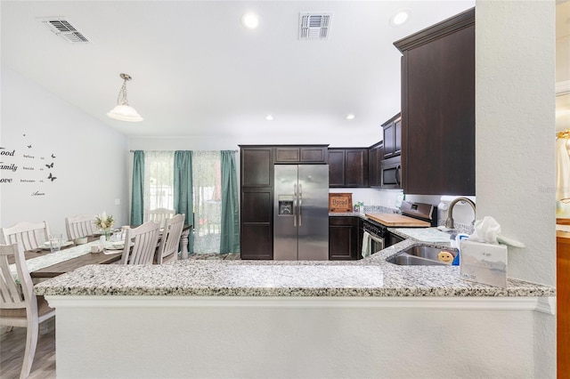 6 Sequoia Loop, Ocklawaha, FL 32179 - kitchen with appliances with stainless steel finishes, light stone counters, dark brown cabinetry, pendant lighting, and recessed lighting