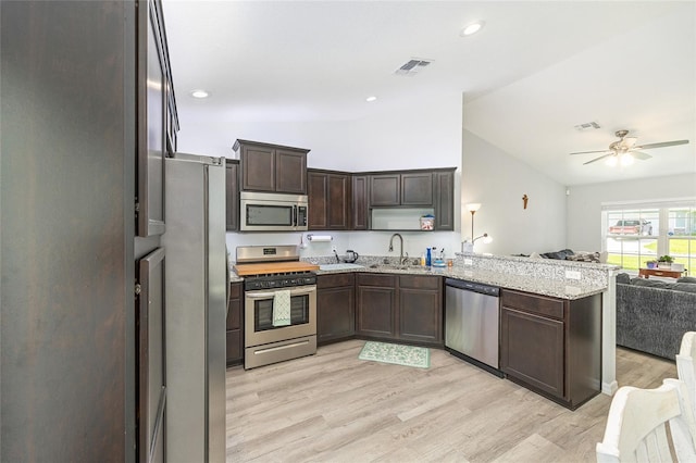 6 Sequoia Loop, Ocklawaha, FL 32179 - kitchen featuring stainless steel appliances, open floor plan, a peninsula, lofted ceiling, and a ceiling fan