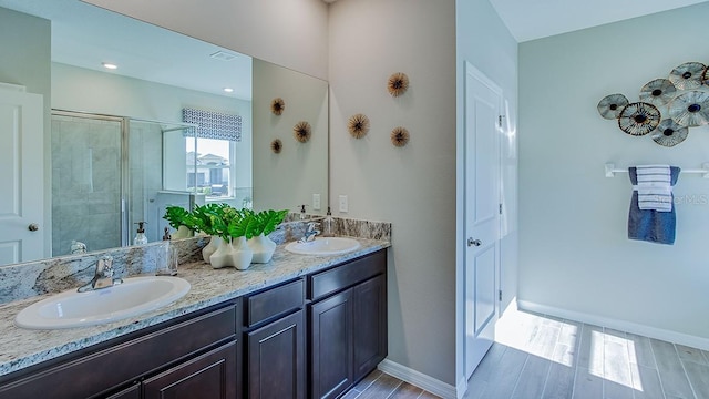 17927 NW 173rd Rd, Alachua, FL 32615 - bathroom with double vanity, a stall shower, and wood finished floors