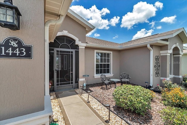 1443 SW 161st St, Ocala, FL 34473 - property entrance featuring stucco siding, roof with shingles, and a patio area