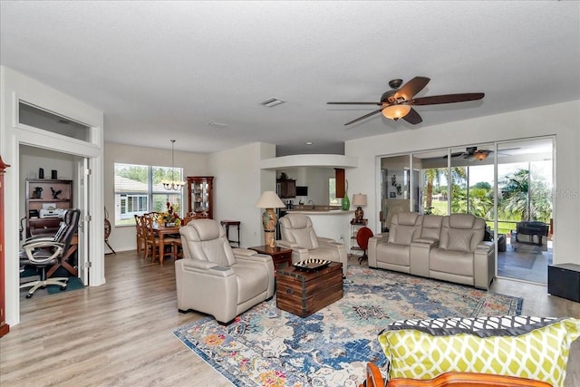 1443 SW 161st St, Ocala, FL 34473 - living area featuring wood finished floors, ceiling fan, a chandelier, and a desk