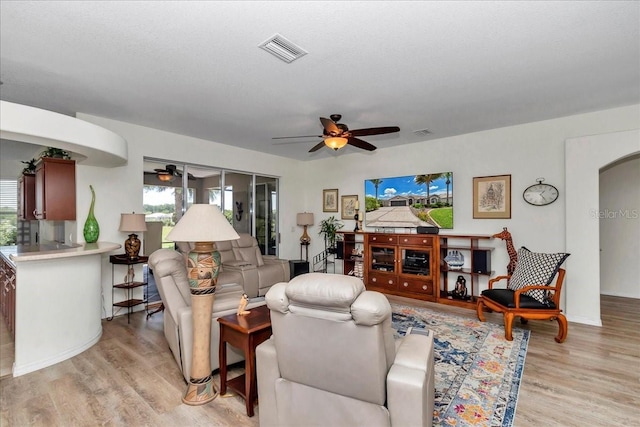 1443 SW 161st St, Ocala, FL 34473 - living room with ceiling fan, light wood-style floors, and arched walkways