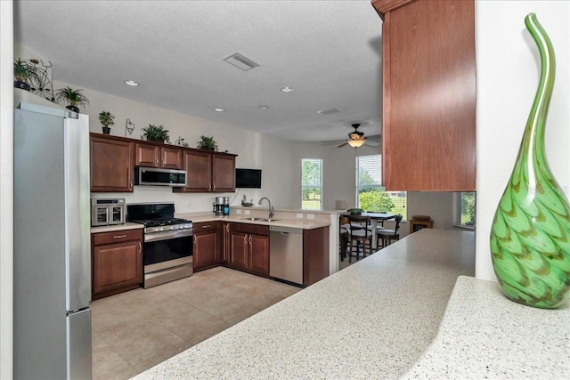 1443 SW 161st St, Ocala, FL 34473 - kitchen featuring stainless steel appliances, light countertops, recessed lighting, a peninsula, and a ceiling fan