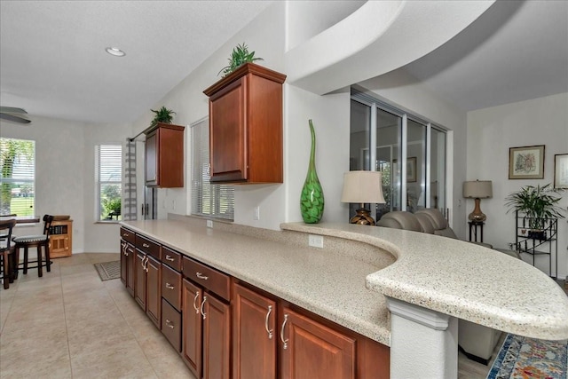 1443 SW 161st St, Ocala, FL 34473 - kitchen featuring light tile patterned flooring, a kitchen breakfast bar, and recessed lighting