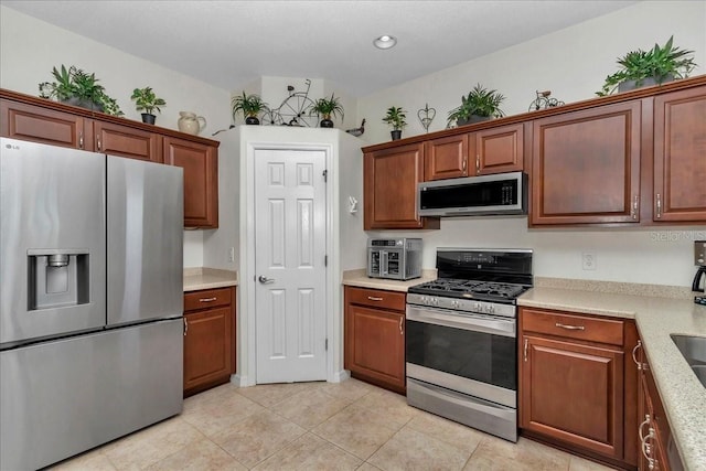 1443 SW 161st St, Ocala, FL 34473 - kitchen with appliances with stainless steel finishes, light countertops, and light tile patterned floors