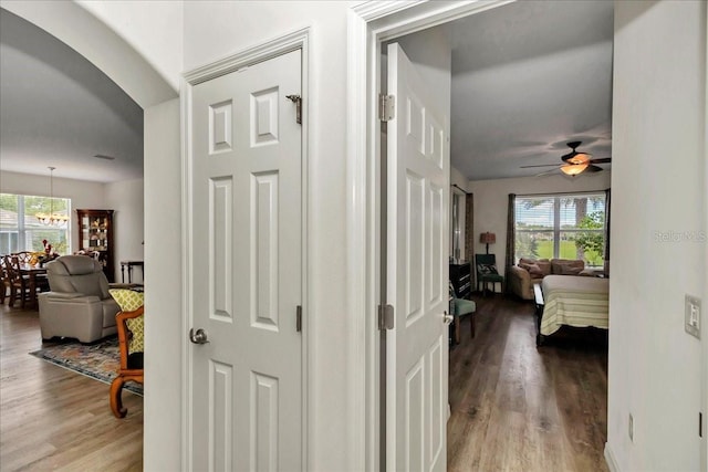 1443 SW 161st St, Ocala, FL 34473 - corridor featuring wood finished floors, a chandelier, and arched walkways