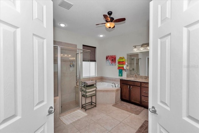 1443 SW 161st St, Ocala, FL 34473 - bathroom with ceiling fan, vanity, a bath, a stall shower, and recessed lighting