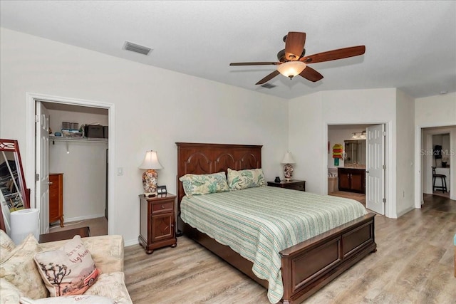 1443 SW 161st St, Ocala, FL 34473 - bedroom featuring light wood finished floors, a walk in closet, ensuite bath, a closet, and a ceiling fan