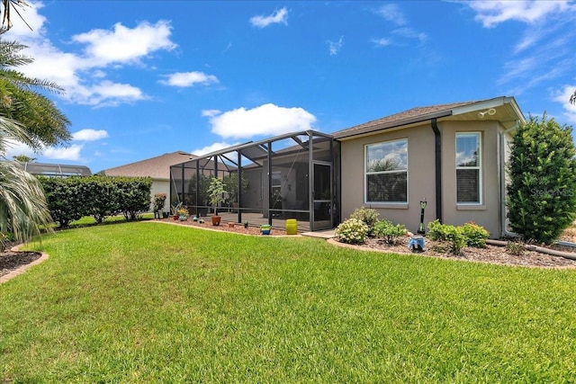 1443 SW 161st St, Ocala, FL 34473 - back of house with stucco siding, a yard, and glass enclosure