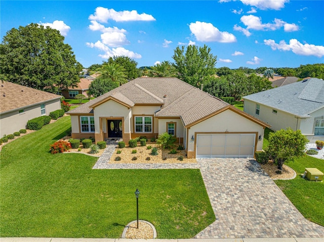 9120 SE 125th Loop, Summerfield, FL 34491 - single story home with stucco siding, a garage, driveway, a front lawn, and a shingled roof