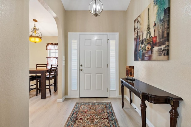 12178 SE 174th Pl, Summerfield, FL 34491 - entrance foyer featuring wood finished floors, arched walkways, and a textured wall