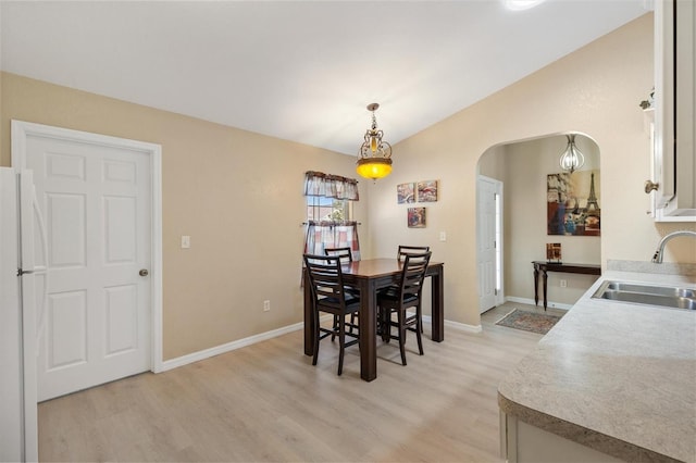 12178 SE 174th Pl, Summerfield, FL 34491 - dining area featuring light wood finished floors, arched walkways, and lofted ceiling