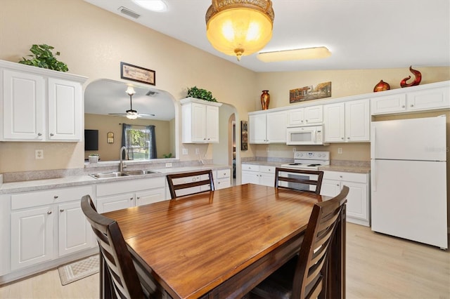 12178 SE 174th Pl, Summerfield, FL 34491 - dining area featuring arched walkways, vaulted ceiling, a ceiling fan, and light wood-style floors