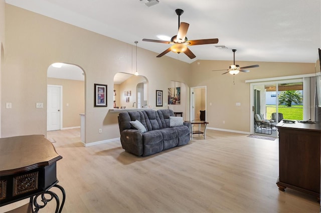 12178 SE 174th Pl, Summerfield, FL 34491 - living room with arched walkways, ceiling fan, light wood-type flooring, and high vaulted ceiling