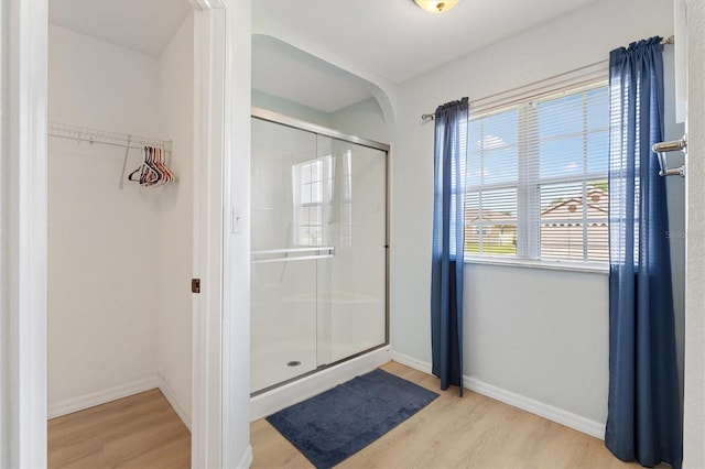 12178 SE 174th Pl, Summerfield, FL 34491 - bathroom with wood finished floors, a shower stall, and a spacious closet