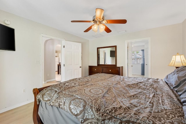 12178 SE 174th Pl, Summerfield, FL 34491 - bedroom featuring arched walkways, light wood-type flooring, and a ceiling fan