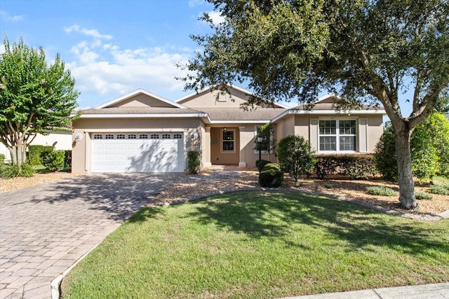 9926 SW 95th Loop, Ocala, FL 34481 - ranch-style house featuring an attached garage, decorative driveway, stucco siding, and a front yard