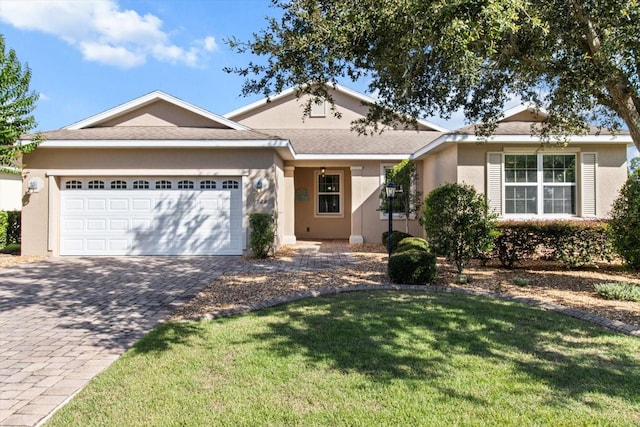 9926 SW 95th Loop, Ocala, FL 34481 - single story home featuring a garage, decorative driveway, stucco siding, and a front lawn
