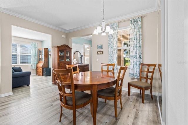9926 SW 95th Loop, Ocala, FL 34481 - dining area with light wood finished floors, a chandelier, and ornamental molding