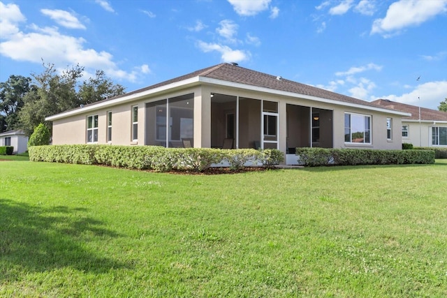 9926 SW 95th Loop, Ocala, FL 34481 - rear view of house with a sunroom, a lawn, and stucco siding