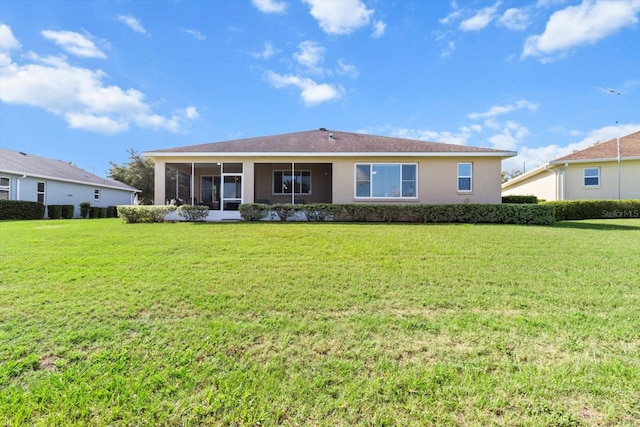 9926 SW 95th Loop, Ocala, FL 34481 - rear view of property featuring a lawn, stucco siding, and a sunroom