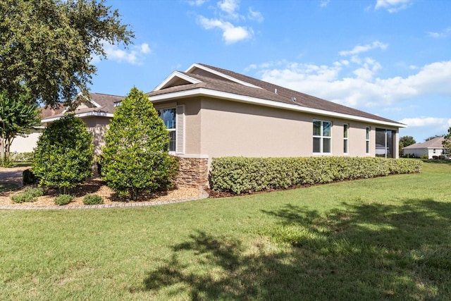 9926 SW 95th Loop, Ocala, FL 34481 - view of side of property featuring stucco siding, a yard, and stone siding