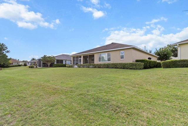 9926 SW 95th Loop, Ocala, FL 34481 - rear view of house featuring a lawn and stucco siding