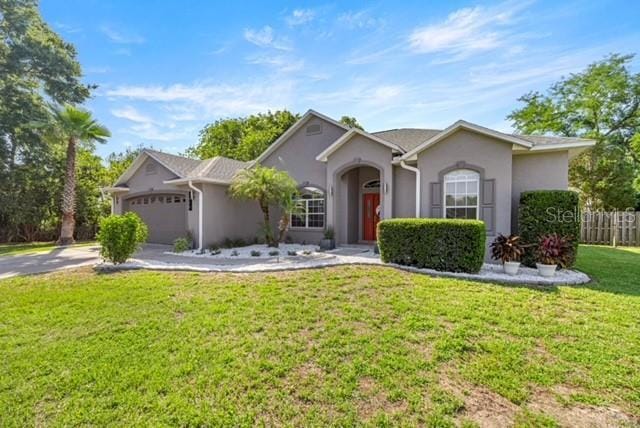 2418 SE 22nd Pl, Ocala, FL 34471 - single story home featuring an attached garage, stucco siding, and driveway